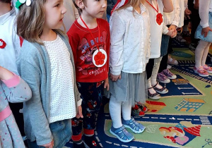 Dzieci z grup starszych podczas obchodów 11 listopada dzieci stoją i śpiewają hymn narodowy