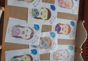 Na zdjęciu pokazane są skończone prace dzieci- kolorowanki przedstawiające dziewczynkę z zespołem Downa.