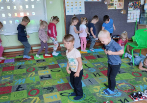 Na zdjęciu dzieci z grupy zielonej podczas obchodów Dnia przedszkolaka dzieci bawią się na dywanie w tor przeszkód